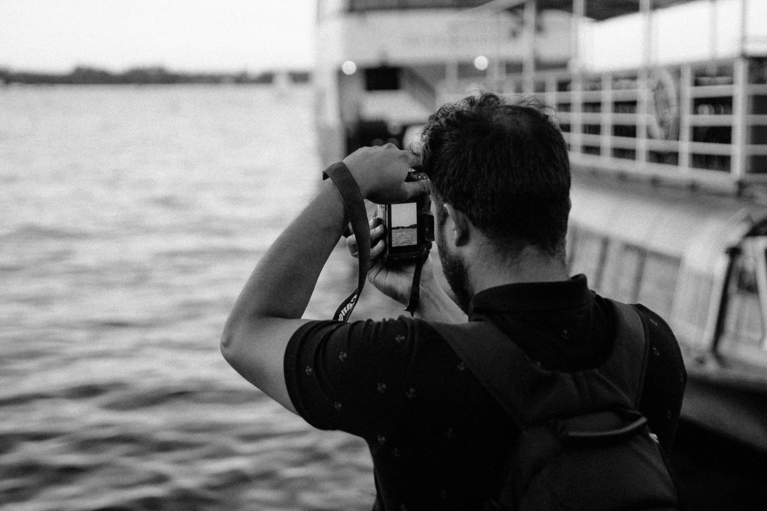 Fotografo naturalista al lavoro durante una sessione pratica sul campo